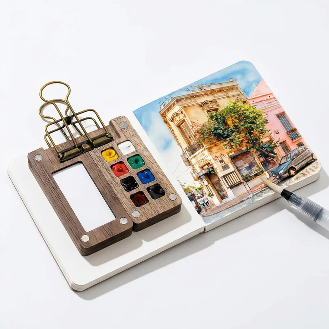 Carried Canvas 12-color mini travel watercolor set with walnut grid palette, sketchbook, brass binder clip and water brush pen
